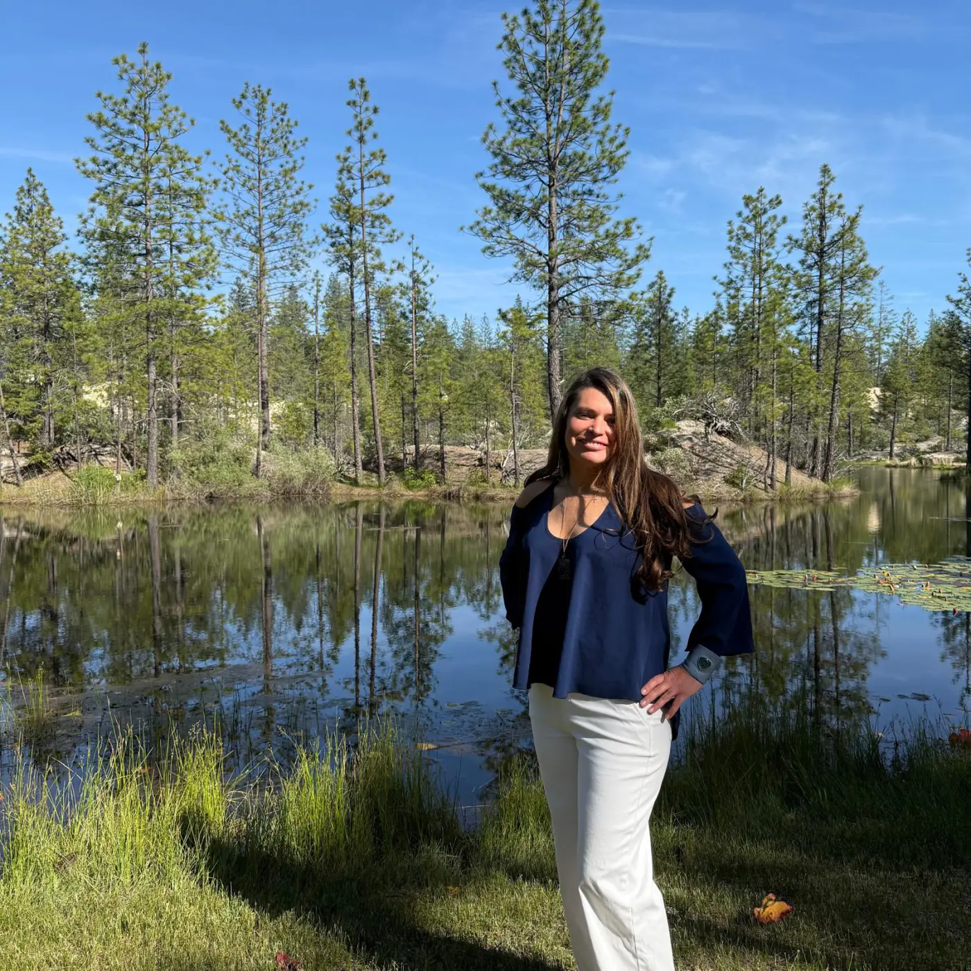 Athena Rose beside a tranquil forest pond